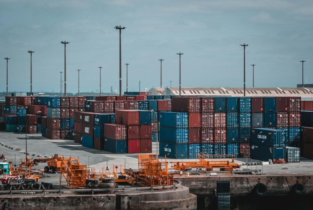 pexels photo 1427541 1427541 Colorful cargo containers stacked at a busy industrial port, showcasing global trade.