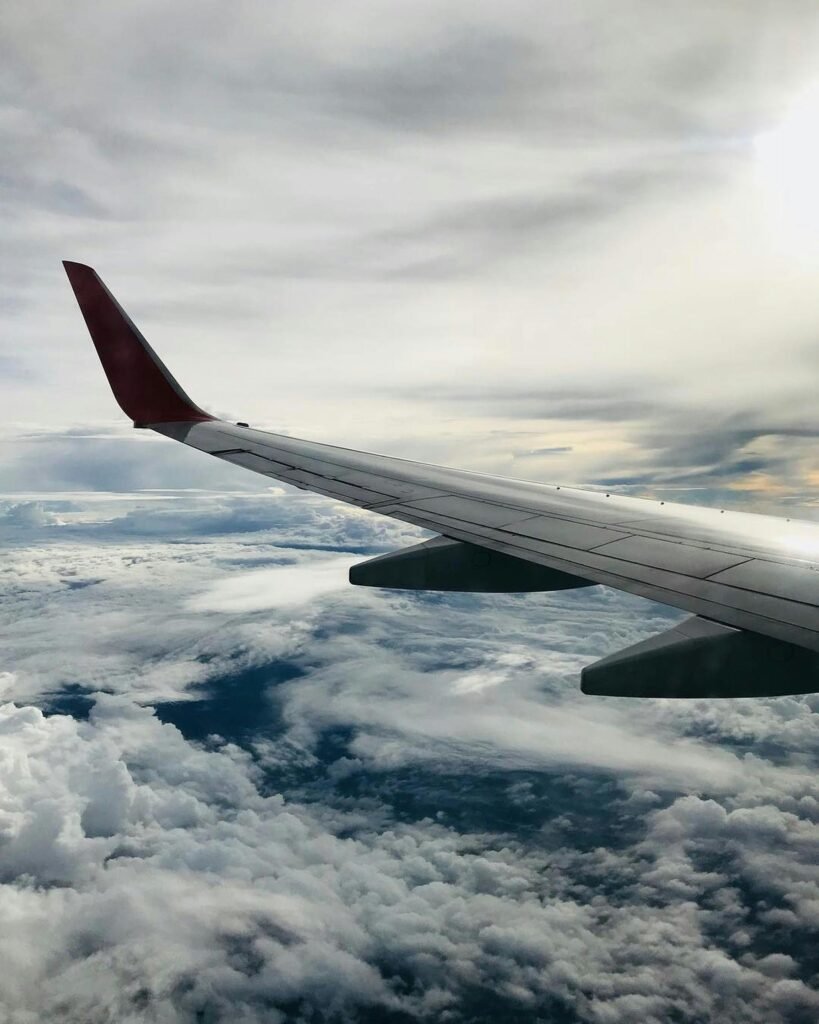 pexels photo 1687633 1687633 A stunning aerial view of fluffy clouds and an airplane wing during daylight flying.